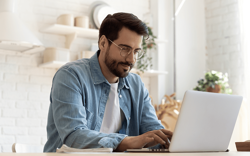 Search Technology man using his laptop